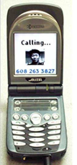 Flip phone programmed to call one number. On the screen is a head shot of a person, with the word "Calling ..." above the picture, and the phone number below